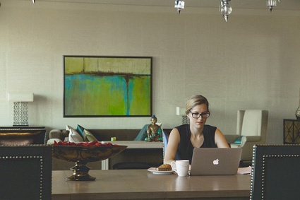 Image of woman sitting at table on laptop. Customers matter in website design. Image of woman sitting at table on laptop. Customers matter in website design.