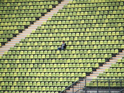 Image of one man sitting in empty stadium. If you aren't using inbound marketing, you too could be wondering where your audience went.