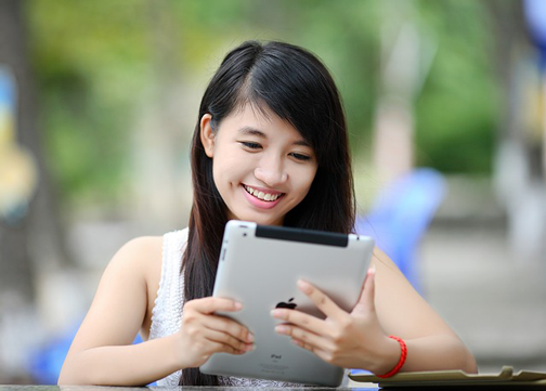 Image of woman using iPad to interact with website design.