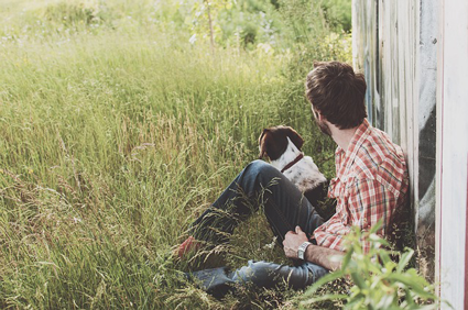 Image of man sitting with dog. Choose wisely when selecting friends and marketing agencies.