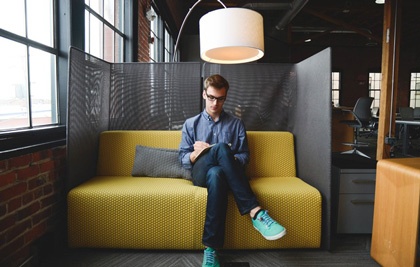 Image of man with notepad seated for interview.