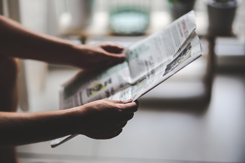 Image of man reading a newspaper. Public relations is still an important part of digital marketing.