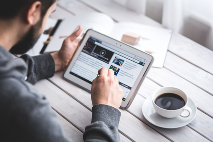 Image of a man using a tablet, being nurtured by inbound marketing strategies.