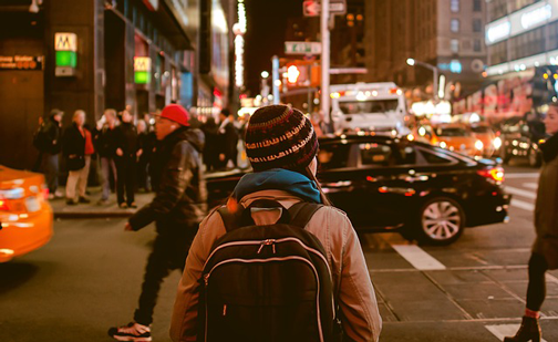 Image of woman standing in crowd in city. People are innundated with all kinds of information. Inbound marketing helps cut through that.