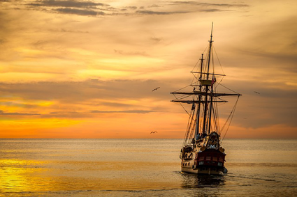 Image of ship sailing into sunset. Inbound marketing assessments don't guarantee smooth sailing, but they help keep marketing plans and strategies on track.