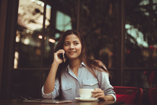 Image of woman talking on phone. Communicate in ways that will enhance customer conversations.