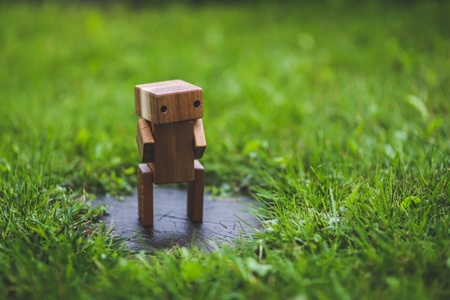 Image of small wooden robot. Marketing automation programs don't need to make your communications robotic.