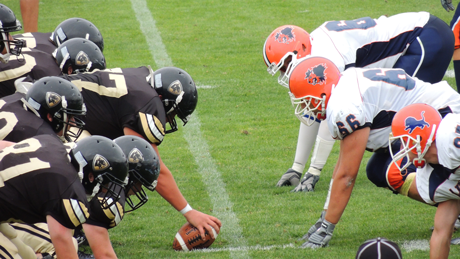 Image of football teams at the line of scrimmage. Use inbound marketing strategies to tackle marketing challenges.