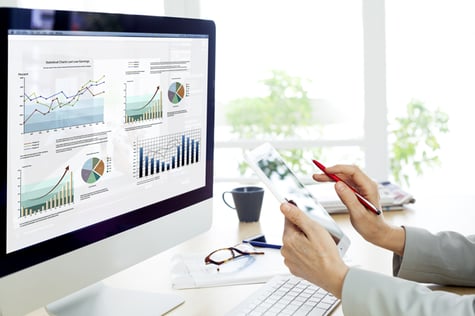 Image of person using computer for marketing analytics and measuring.