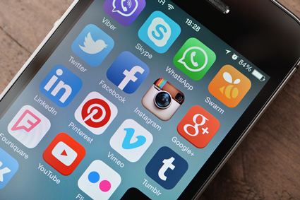 Image of social media icons (Twitter, Instagram, Facebook) on an iPhone screen.